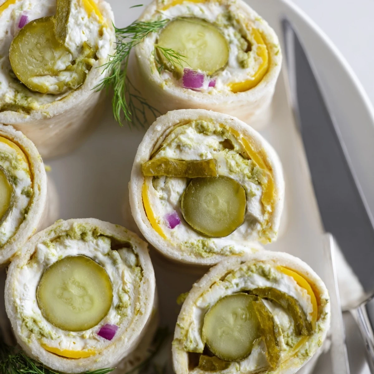 Tangy and creamy, pickle-in-a-blanket bites are ideal for quick appetizers or picnics.