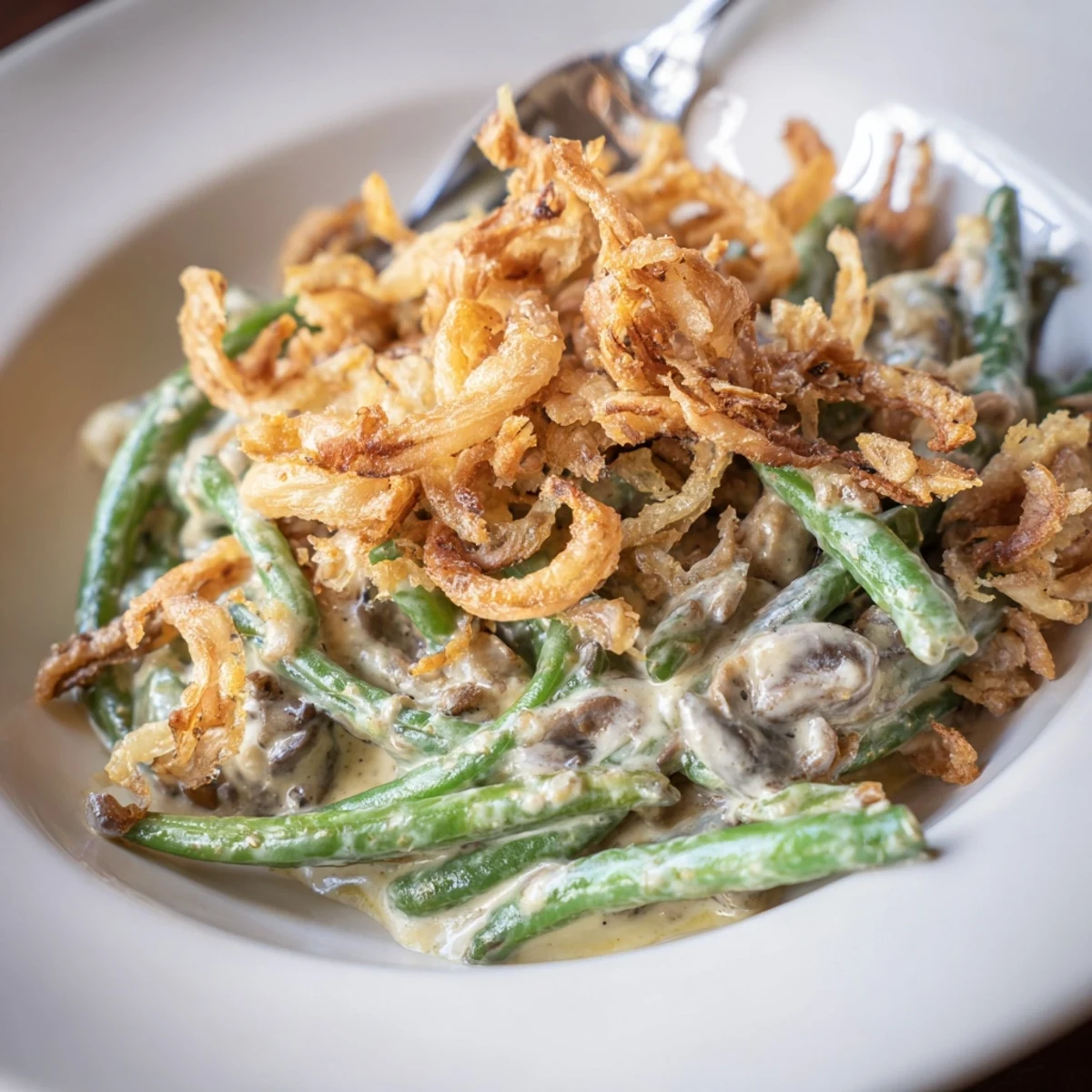 Deliciously creamy Old-School Green Bean Casserole topped with crunchy fried onions.