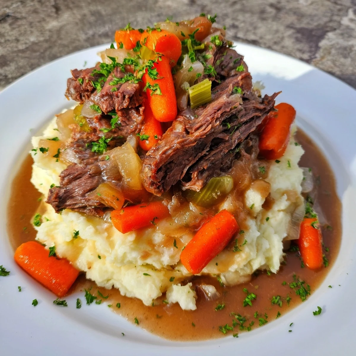 Tender, fall-apart Slow Cooker Pot Roast with creamy mashed potatoes, ready to be enjoyed.