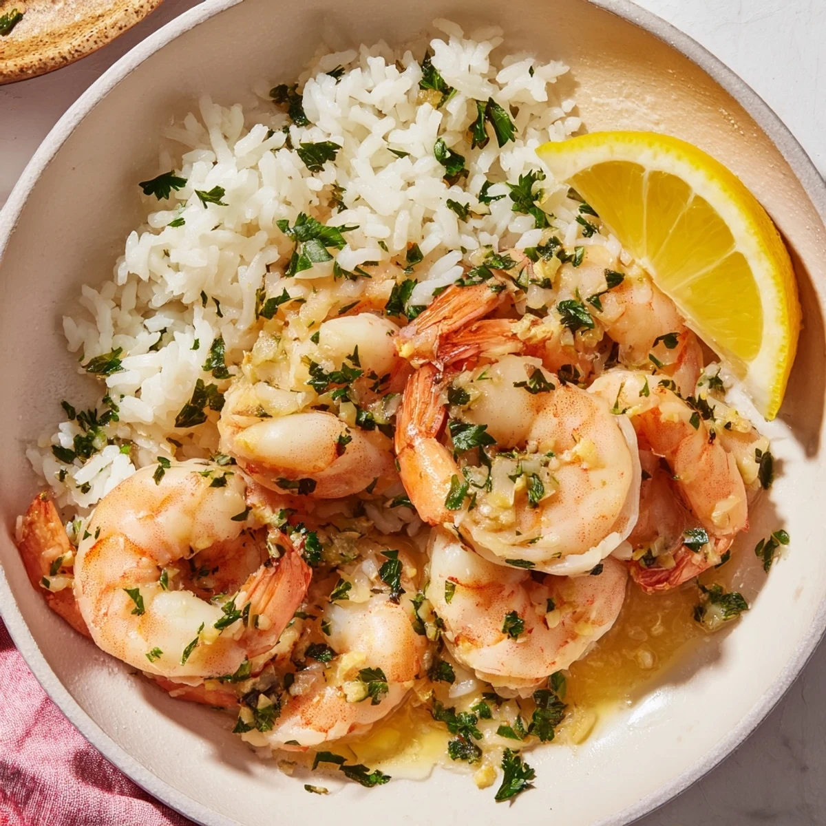 Steaming hot garlic butter shrimp nestled on jasmine rice, a quick and easy American dinner recipe.
