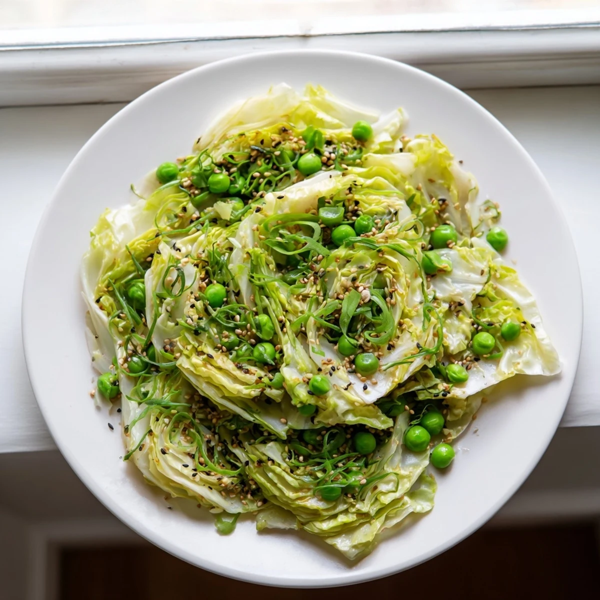 This flavorful cabbage stir-fry features tender cabbage and peas, seasoned with fragrant garlic and sesame oil.