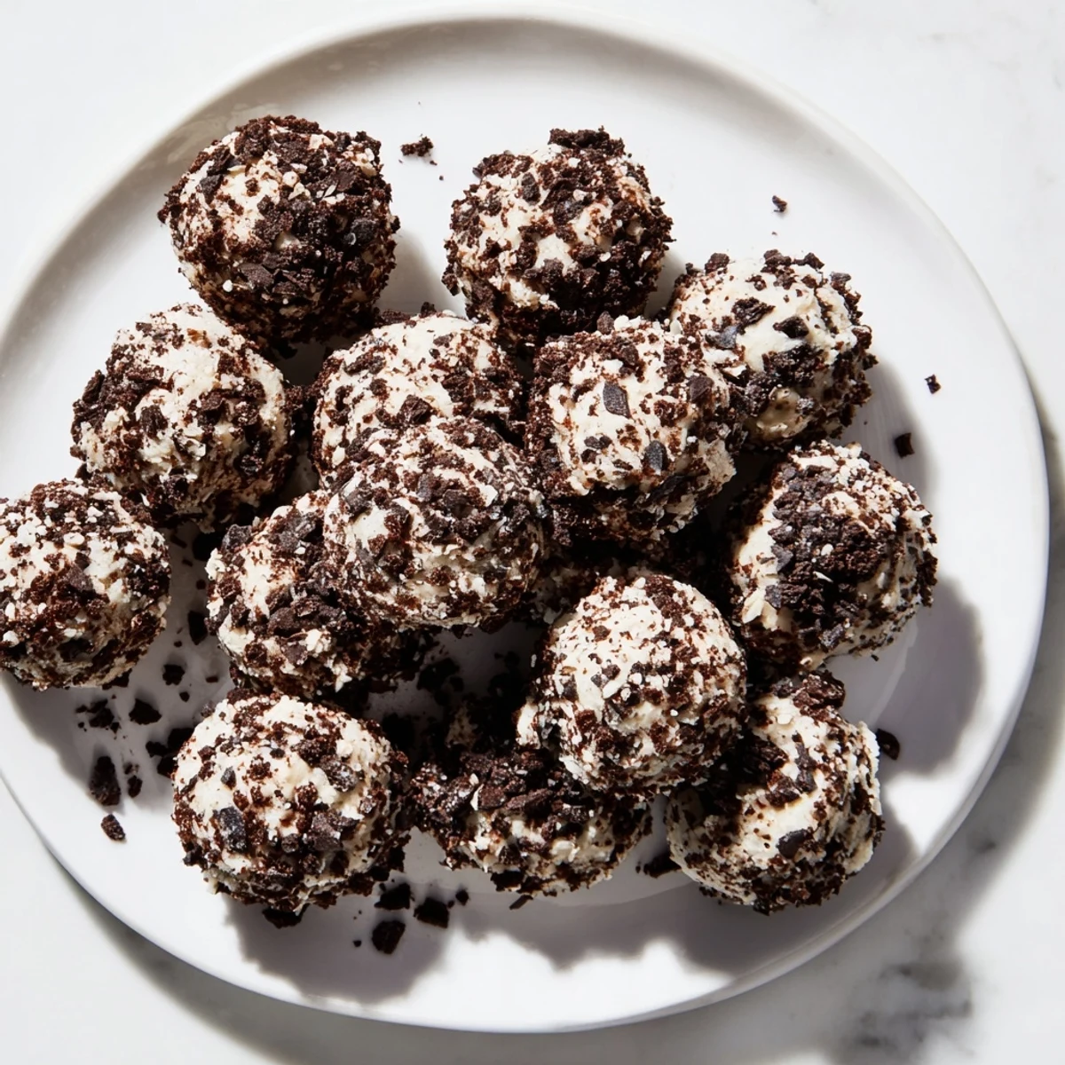 Cream Cheese Oreo Protein Balls displayed: creamy, speckled bites ready to eat, a perfect dessert.