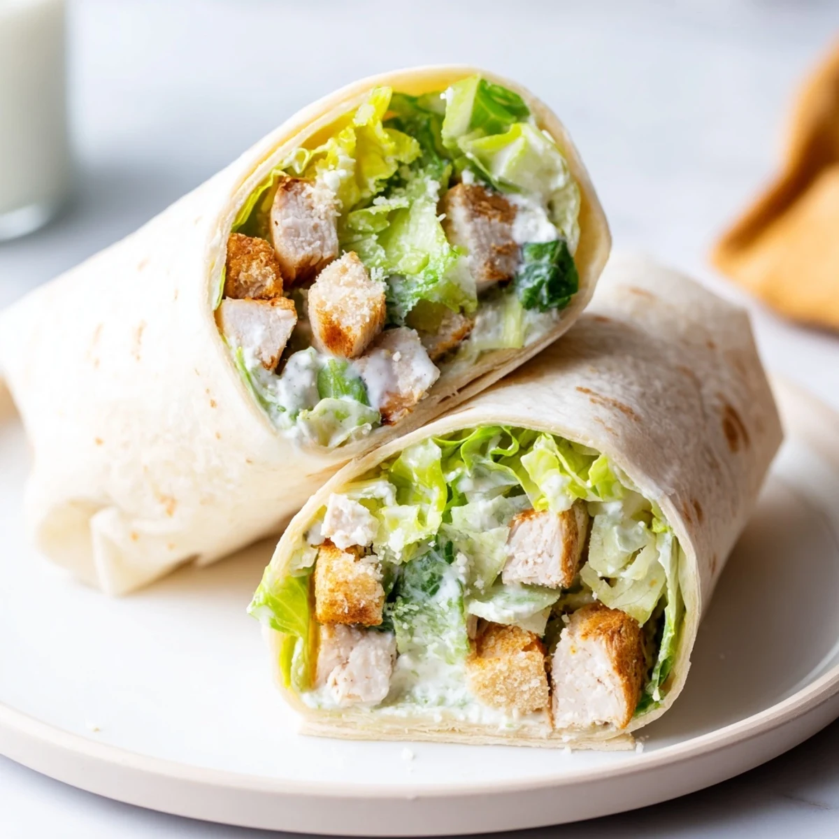 Chicken Caesar Wraps with juicy chicken and creamy dressing, ready to be rolled up.
