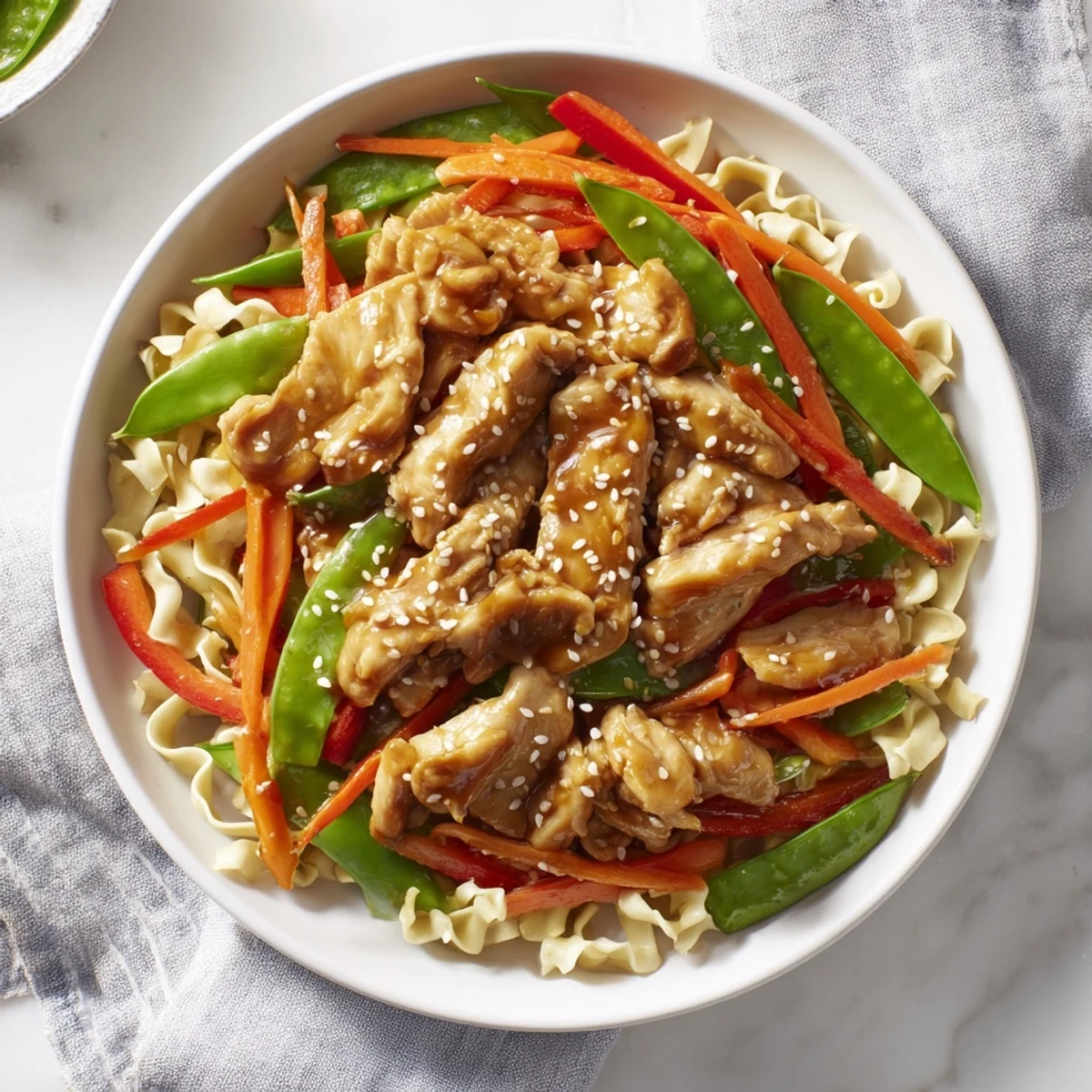 Steaming hot Lemon-Garlic Chicken Stir Fry with noodles, a colorful mix of chicken and veggies.