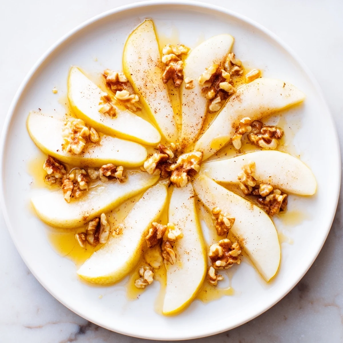 Fresh, juicy pear slices with a golden honey drizzle, making a simple yet elegant dessert.