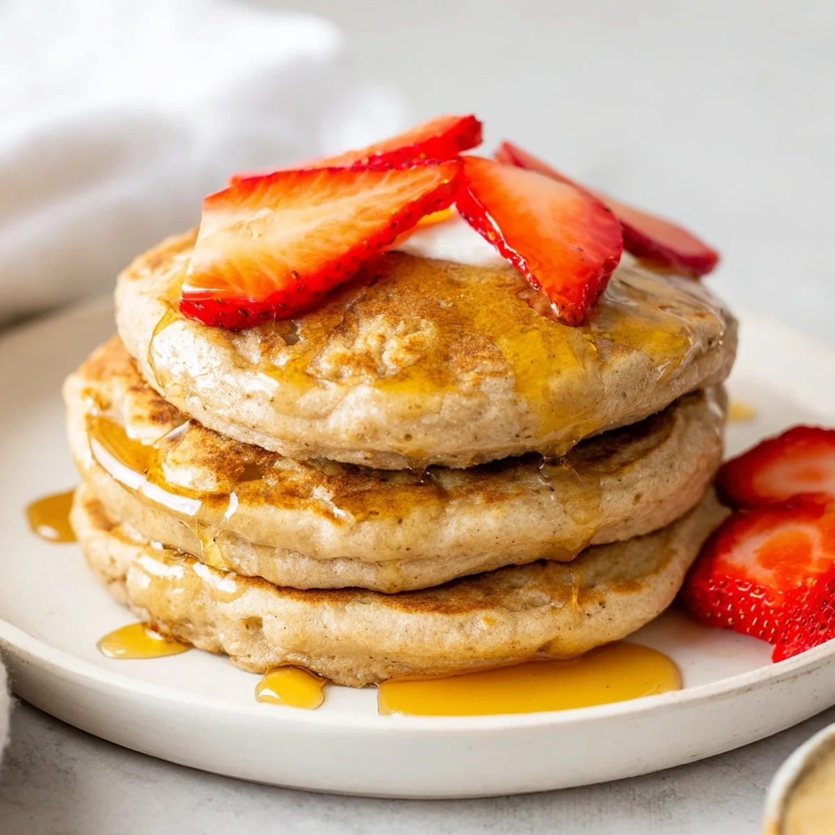 Warm plate of protein banana pancakes with a perfect browning and inviting aroma.