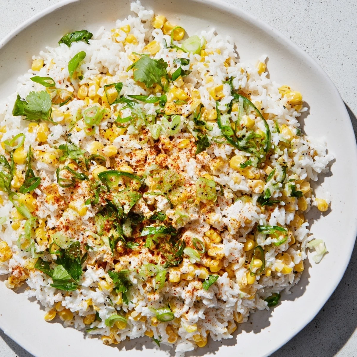 Fluffy Mexican Street Corn Rice, topped with crumbled cheese and fresh cilantro, ready to serve.