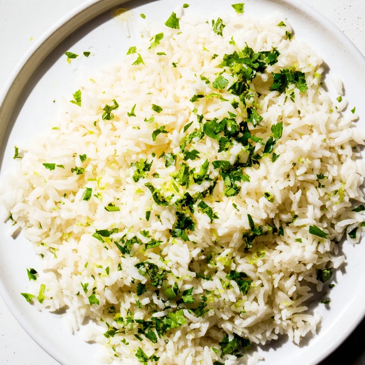 Fluffy cilantro lime rice, infused with fresh zest and herbs, steaming in a bowl.
