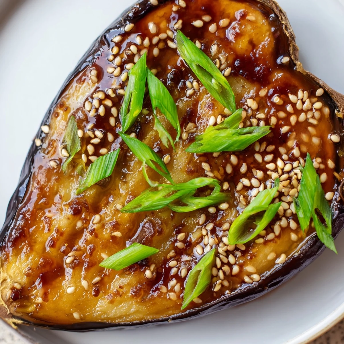 Freshly broiled Miso Glazed Eggplant ready to serve alongside steamed rice for a quick vegan dinner.  