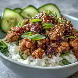 Sesame Turkey Lettuce Wrap Bowls served with lime wedges, pickled radishes, and vibrant carrot matchsticks for a healthy meal.