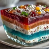 Showcases vivid, layered agar-agar rainbow jelly cake, perfect for any celebration.