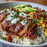 Savory spiced chicken crowns vibrant street corn rice bowls, perfect for dinner.