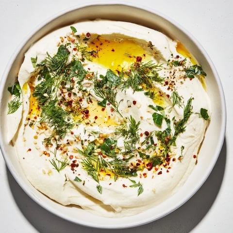 Silky whipped feta dip drizzled with honey, fresh herbs, perfect for serving with toasted pita.