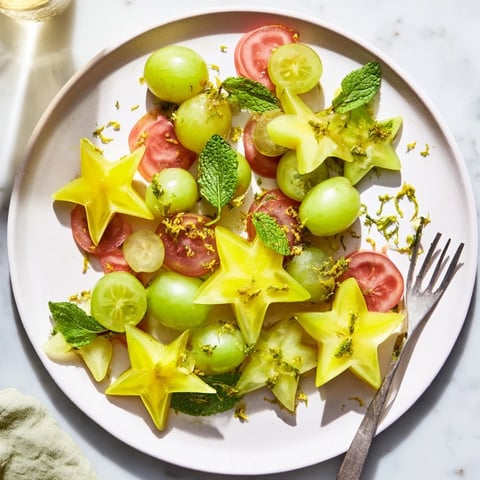 Vibrant Brunch Fruit arrangement featuring starfruit slices and juicy grapes, ideal as a garnish.