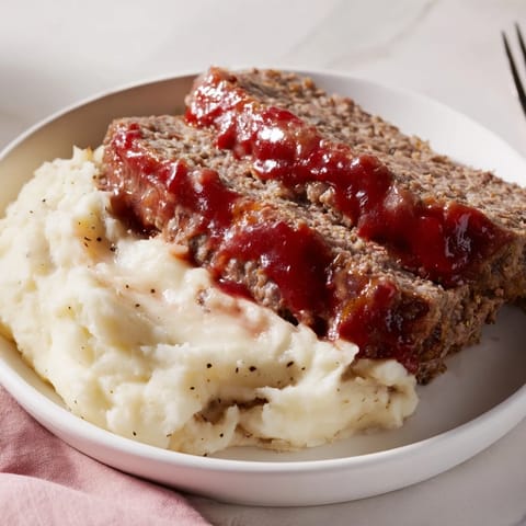 Homemade Classic Meatloaf & Mashed Potatoes, a hearty meal with tender meatloaf and creamy potatoes.