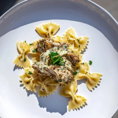 Golden-brown chicken pieces and bowties mingle in this flavorful Mozzarella Garlic Butter Chicken Bowties dish.