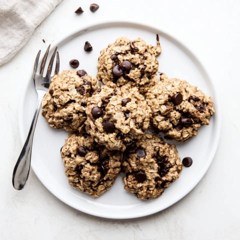 A stack of freshly baked Oat-Banana Chocolate Chip Cookies, perfect for a sweet and easy dessert.