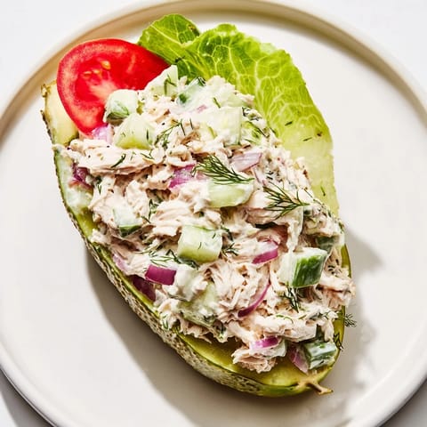 Bright, creamy chicken salad overflowing from hollowed pickles; enjoy this flavorful Pickle Sandwich.