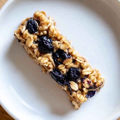 Freshly cut Blueberry Banana Oatmeal Protein Bars, showing a delightful texture and juicy blueberries.