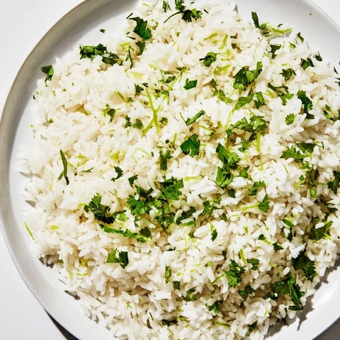 Bright green cilantro lime rice alongside grilled chicken, a flavorful and easy side dish.