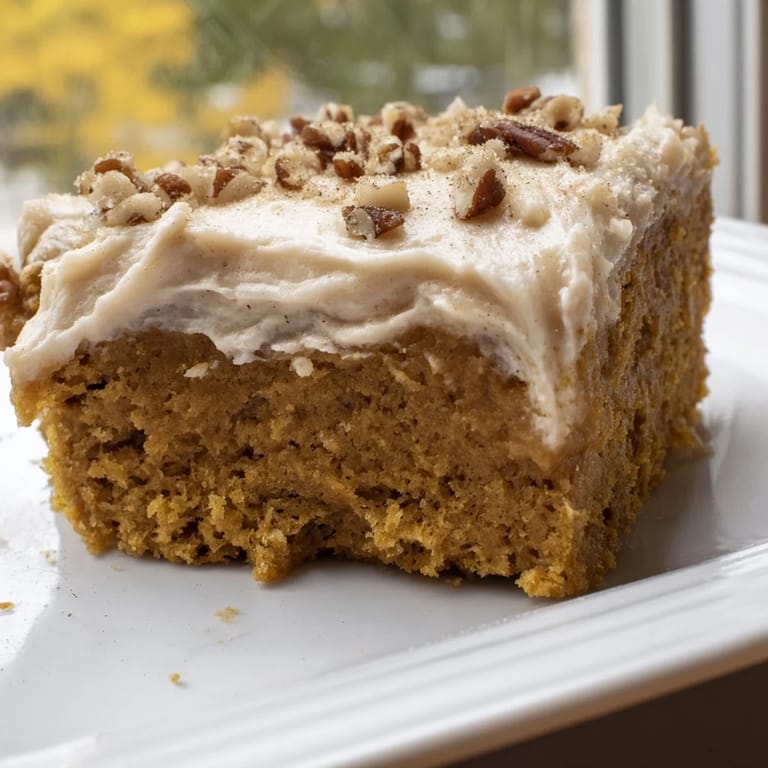 Delicious homemade Pumpkin Bars, beautifully frosted, perfect for a fall dessert spread.