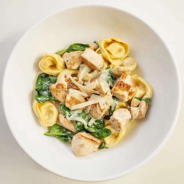 This photo shows Creamy Chicken and Spinach Tortellini, a vibrant medley, ready to be devoured.