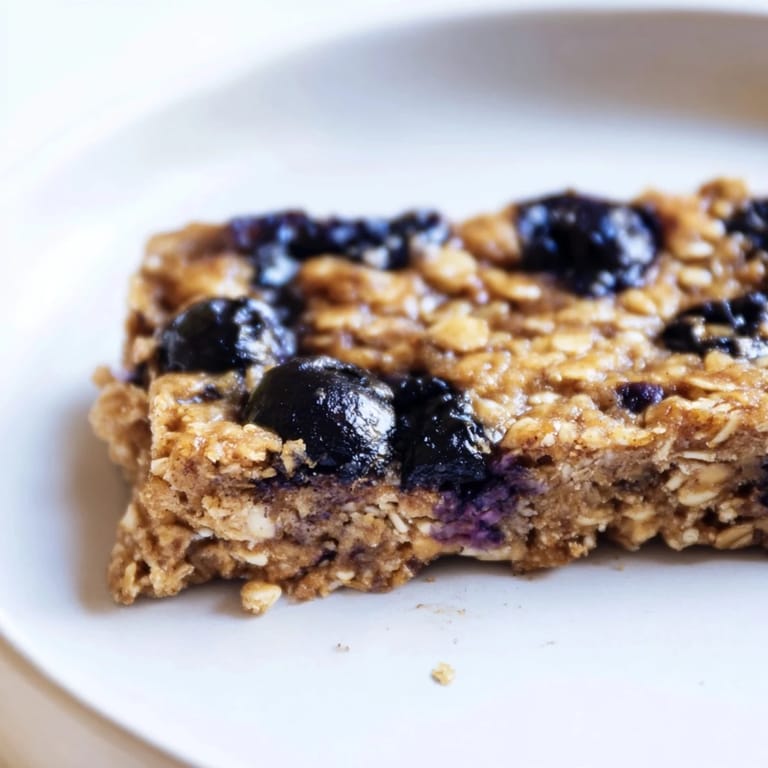 Grab-and-go Blueberry Banana Oatmeal Protein Bars, ideal for a nutritious snack, with perfect golden edges.