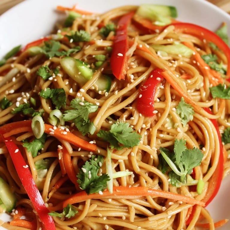 Refreshing Garlic Noodle Salad ready to eat, featuring bright peppers and cilantro, and toasted sesame seeds.