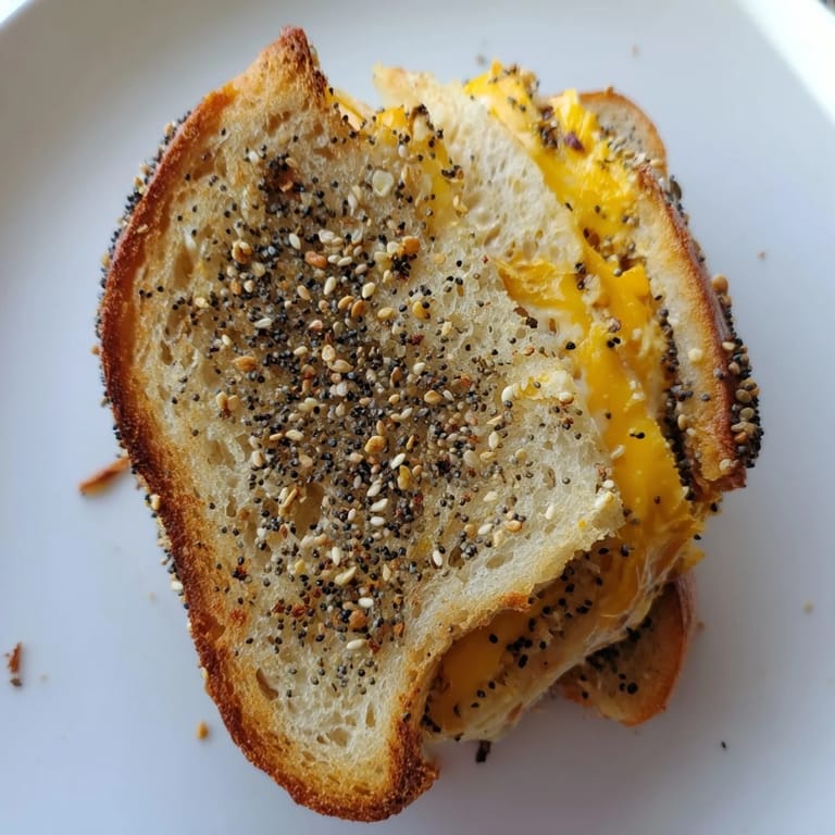 Crispy, seasoned bread surrounds gooey cheese in this delicious Everything Bagel Grilled Cheese recipe.