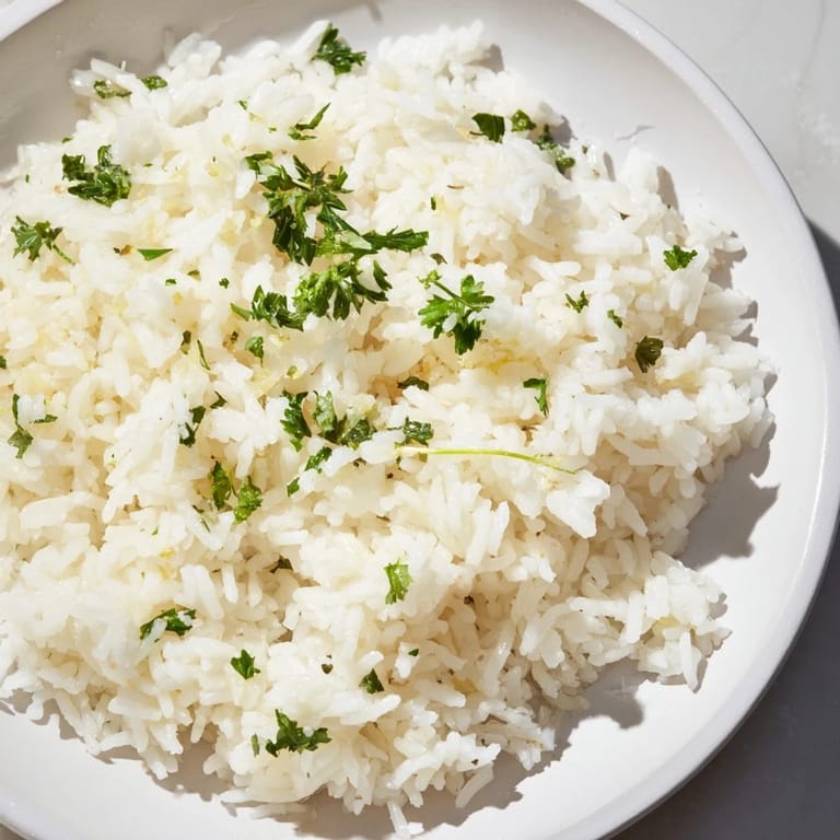 Freshly cooked and fluffy garlic butter rice, a flavorful side dish perfect alongside any main course.