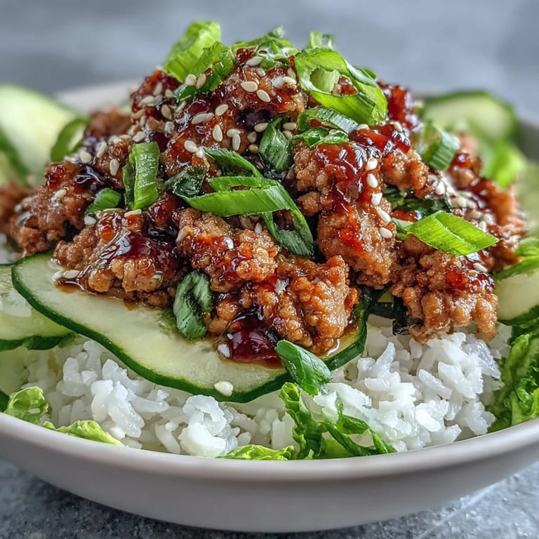 Homemade Sesame Turkey Lettuce Wrap Bowls with juicy ground turkey, fresh herbs, and crunchy vegetables on a bamboo table.